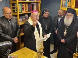Archbishop Hanna Jalloh blessing the new space with holy water.