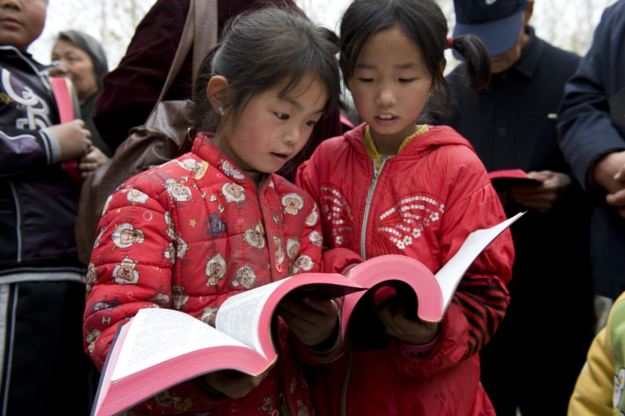Two children reading the Bible